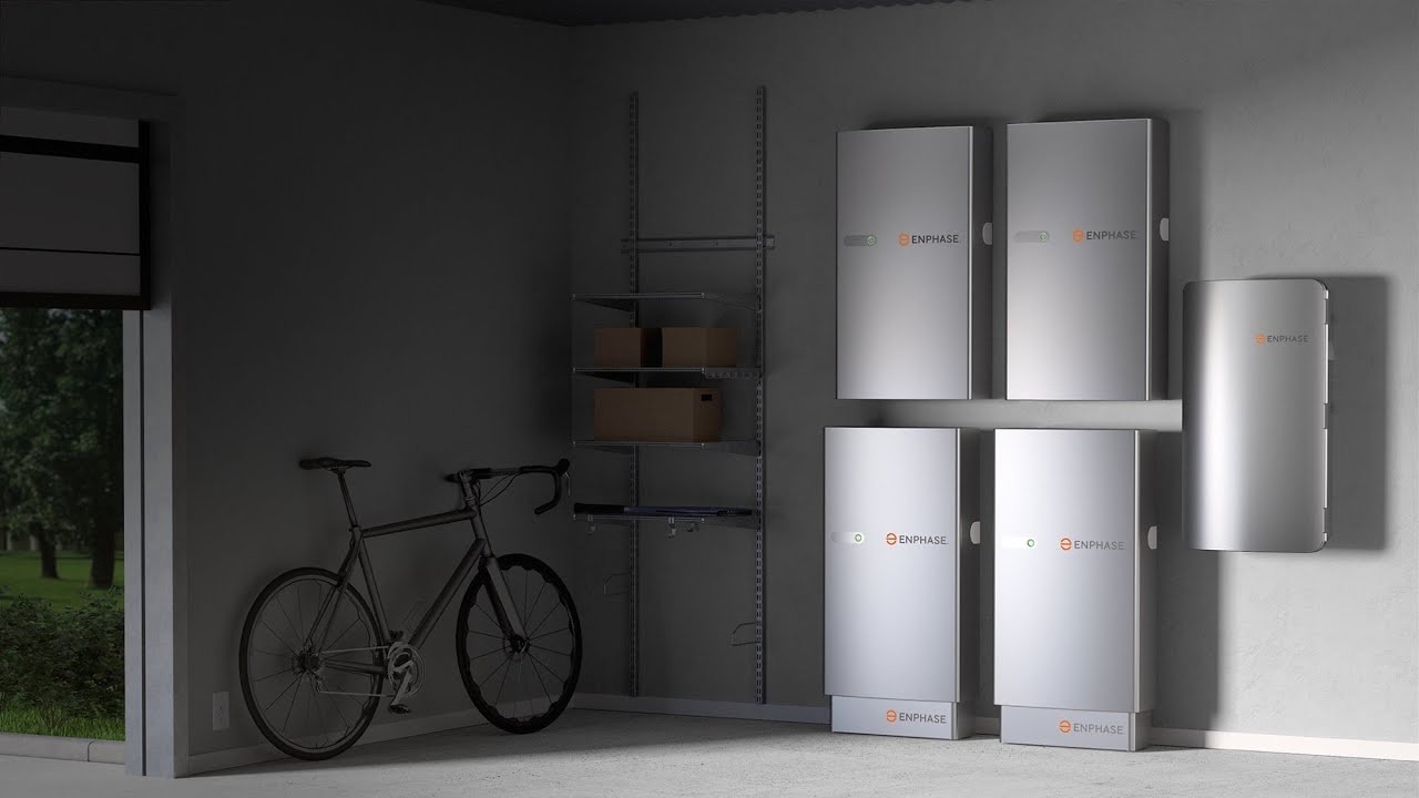 Four Enphase IQ Battery 5P units installed side by side on a garage wall, each a compact white rectangular unit with the Enphase logo